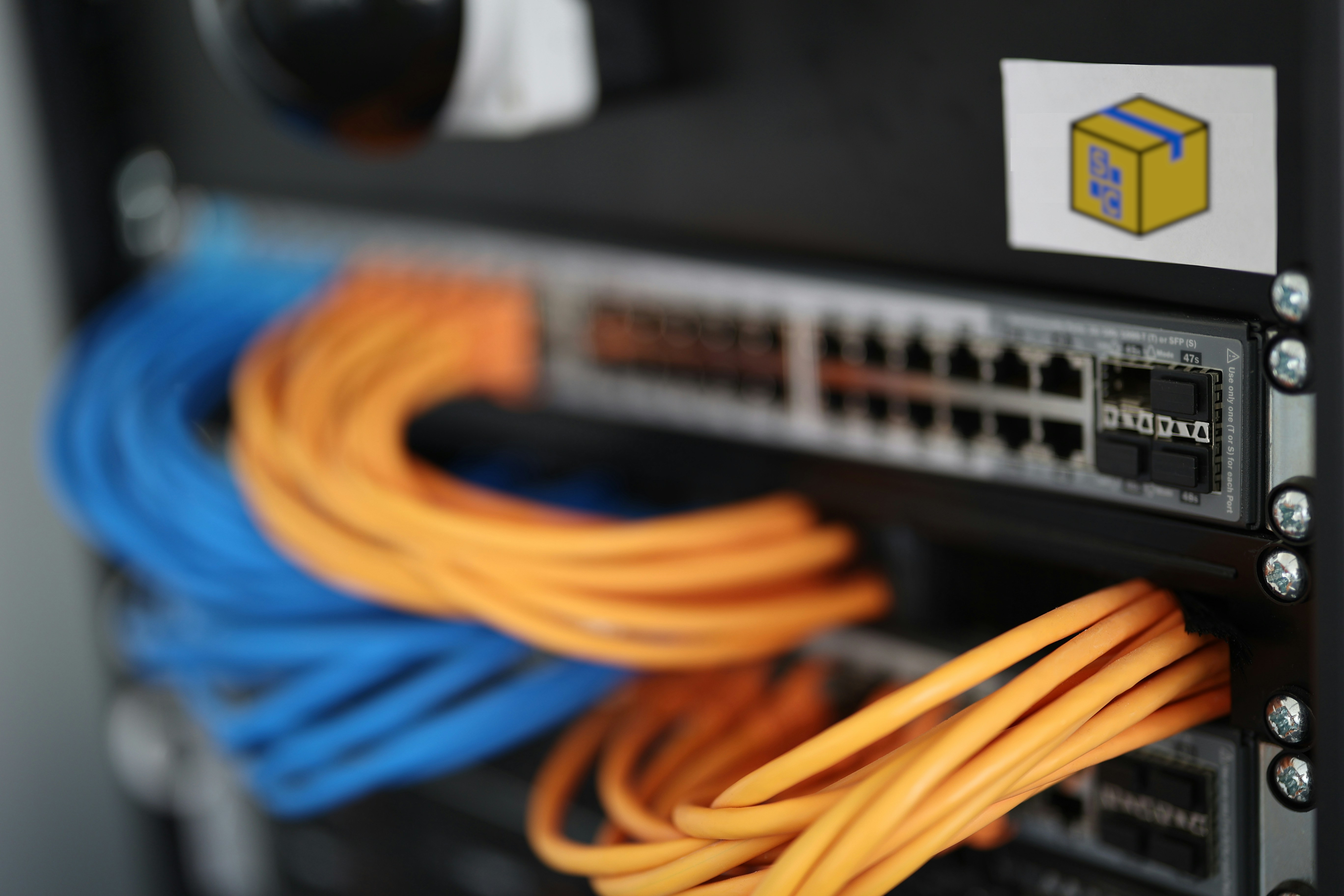 ShelfControl-managed network switch with structured blue and orange patch cabling